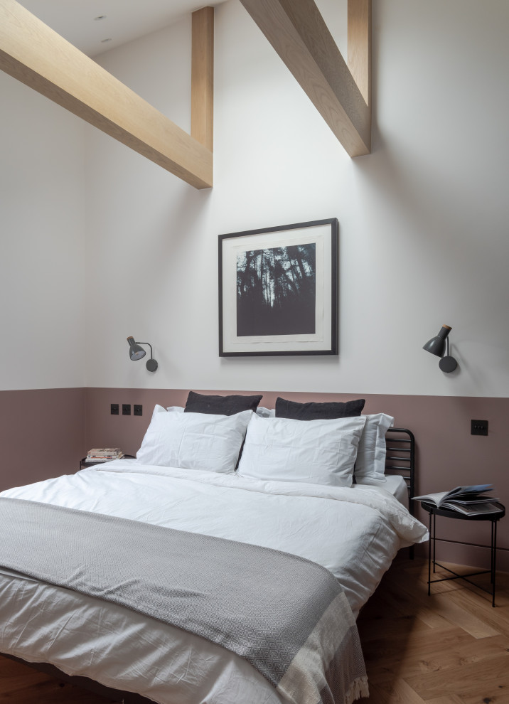 Large trendy master brown floor and medium tone wood floor bedroom photo in London with multicolored walls