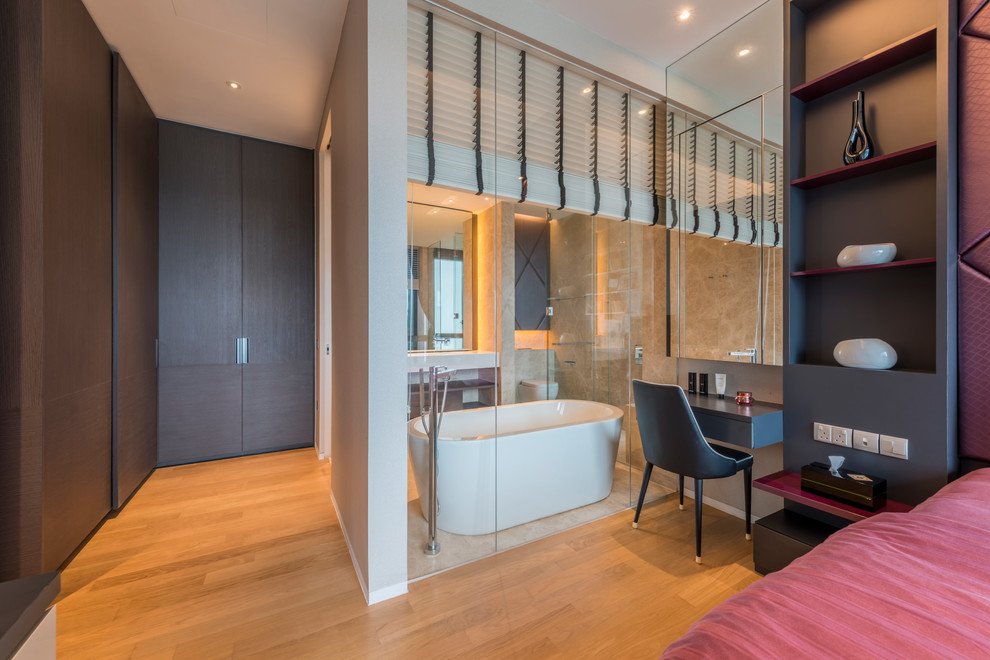 Photo of a contemporary master bedroom in Singapore with medium hardwood flooring and brown floors.