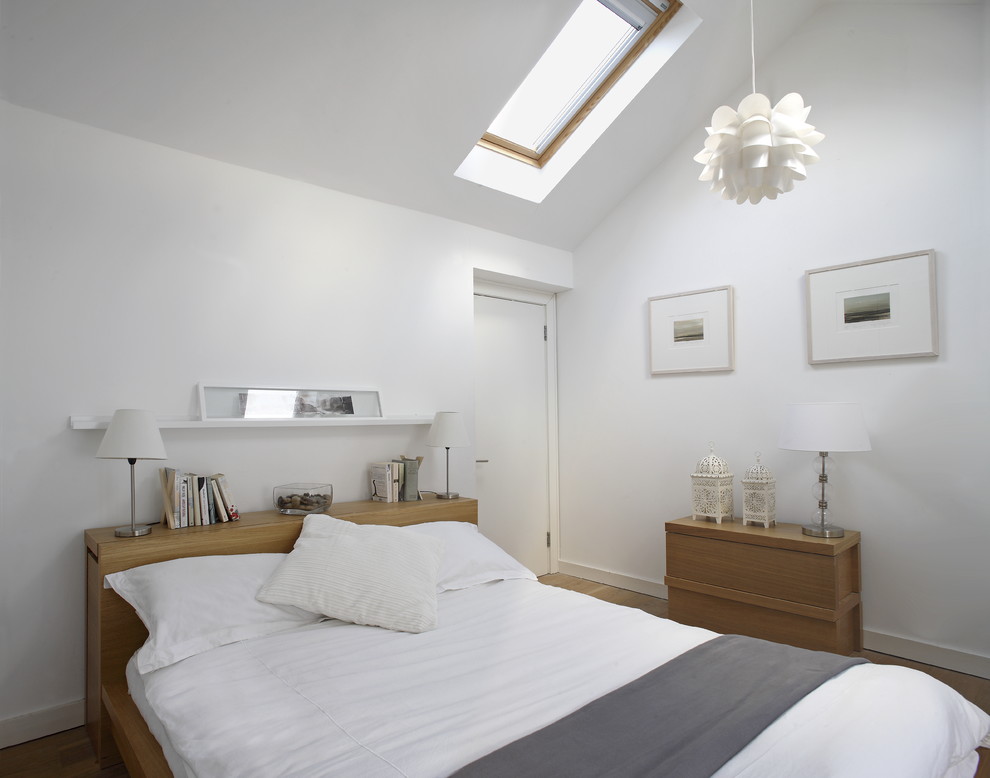 Inspiration for a contemporary bedroom in Dublin with white walls.