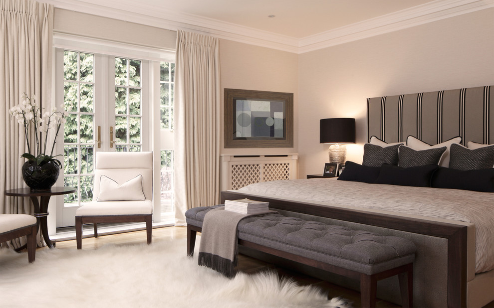 This is an example of a contemporary bedroom in London with grey walls.