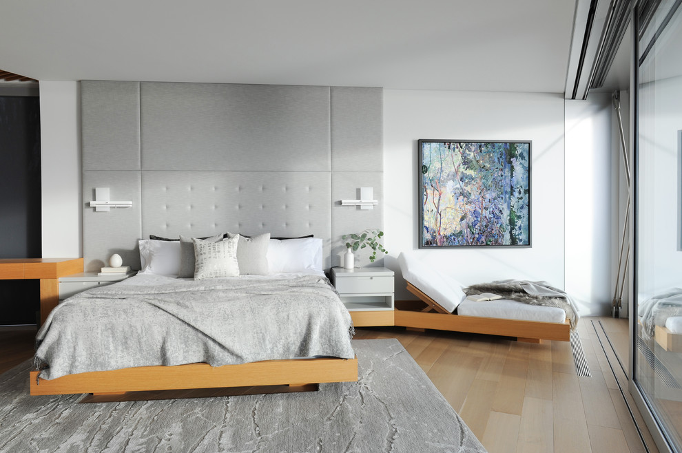 Example of a trendy master light wood floor and beige floor bedroom design in Vancouver with white walls and no fireplace