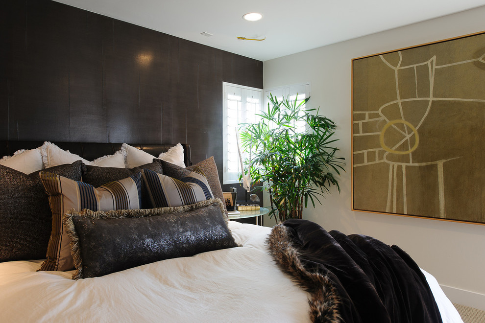 Contemporary bedroom in Los Angeles with black walls, carpet and no fireplace.