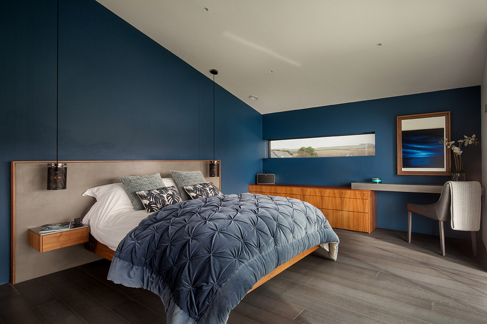 Inredning av ett modernt sovrum, med blå väggar och grått golv