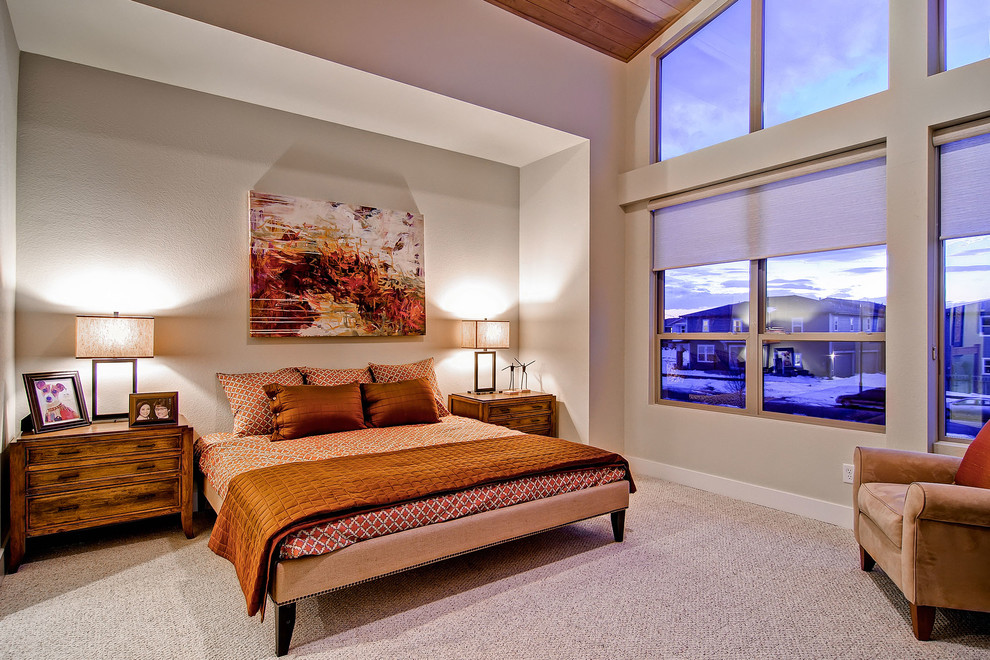 Inspiration for a contemporary bedroom in Denver with beige walls and carpet.