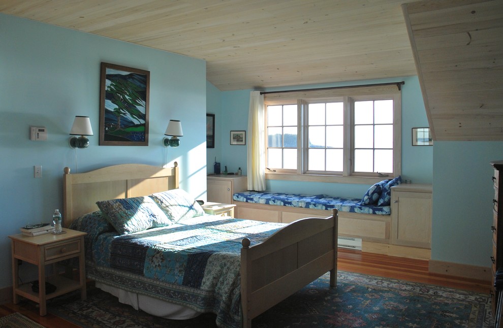 Photo of a medium sized nautical master bedroom in Portland Maine with blue walls and medium hardwood flooring.