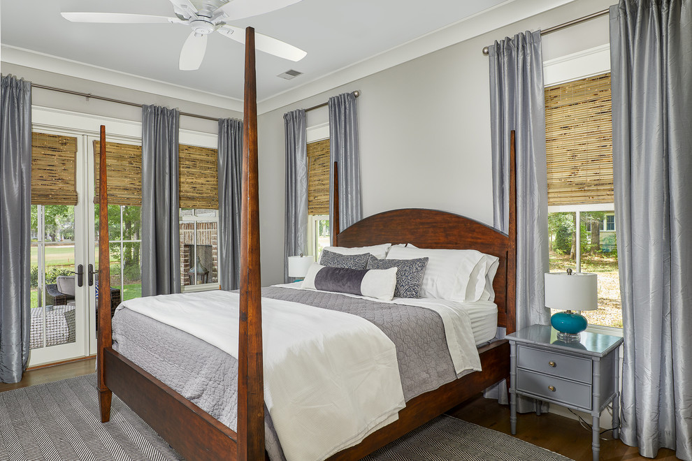 Large beach style master brown floor bedroom photo in Charleston with gray walls