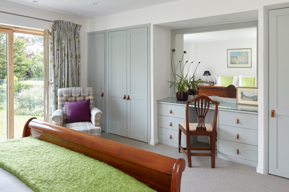 Large trendy guest carpeted bedroom photo in Berkshire with white walls