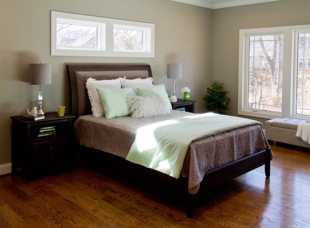 Example of a large arts and crafts master medium tone wood floor bedroom design in St Louis with gray walls