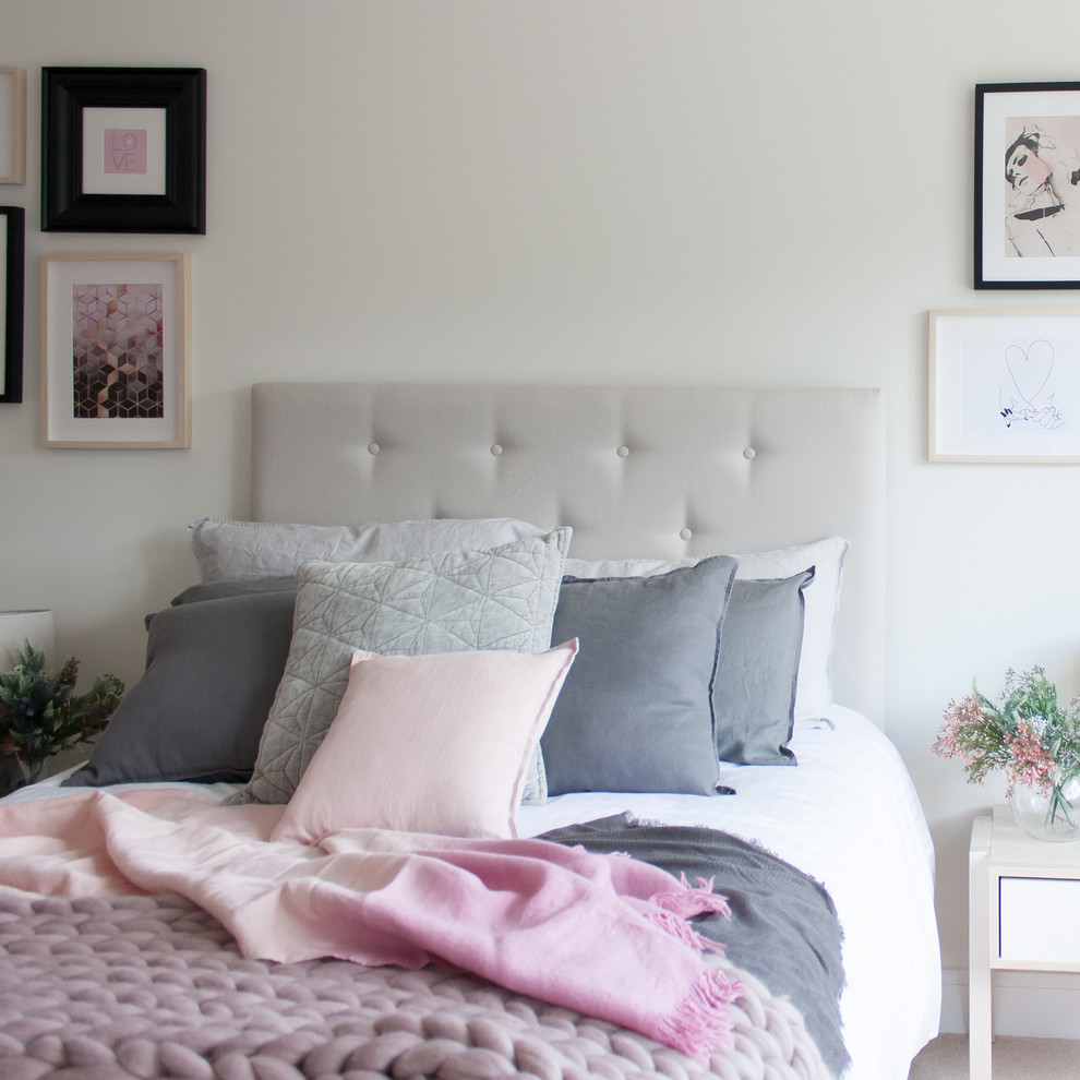 Inspiration for a medium sized modern guest and grey and pink bedroom in Hertfordshire with white walls, carpet and beige floors.