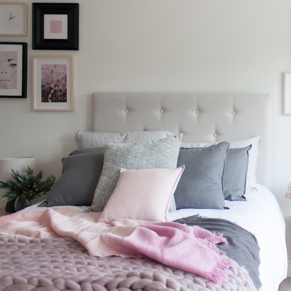 Design ideas for a medium sized modern guest and grey and pink bedroom in Hertfordshire with white walls, carpet and beige floors.