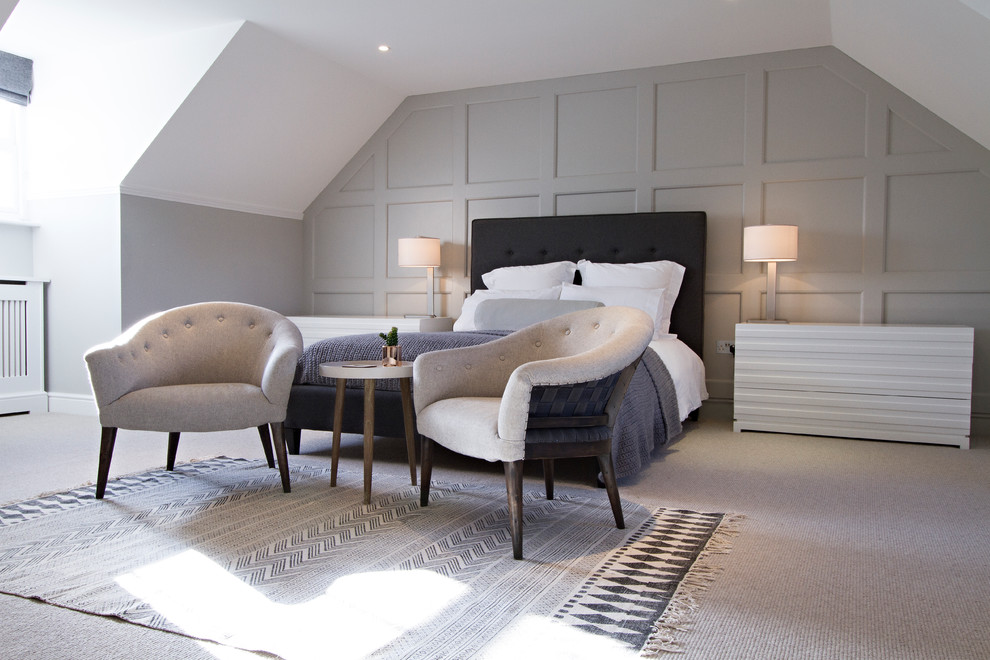 This is an example of a large contemporary guest bedroom in Surrey with grey walls and carpet.