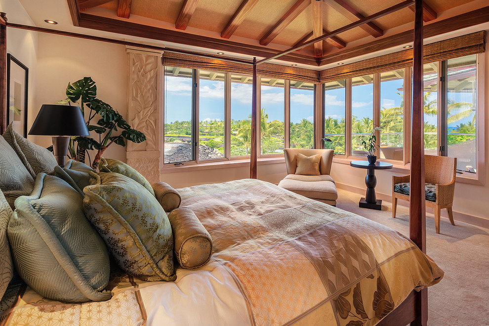 Inspiration for a large world-inspired master bedroom in Hawaii with beige walls and carpet.