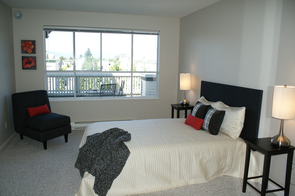 This is an example of a medium sized contemporary master bedroom in Vancouver with white walls and carpet.