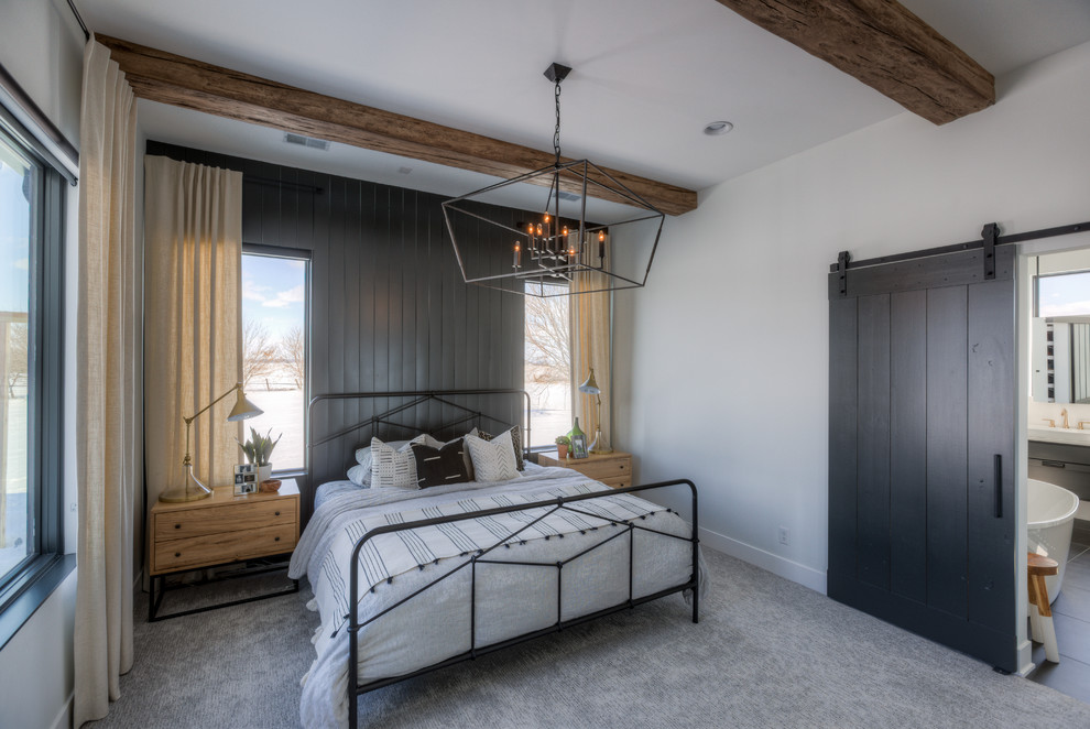 This is an example of a rural master bedroom in Omaha with grey walls, carpet and grey floors.