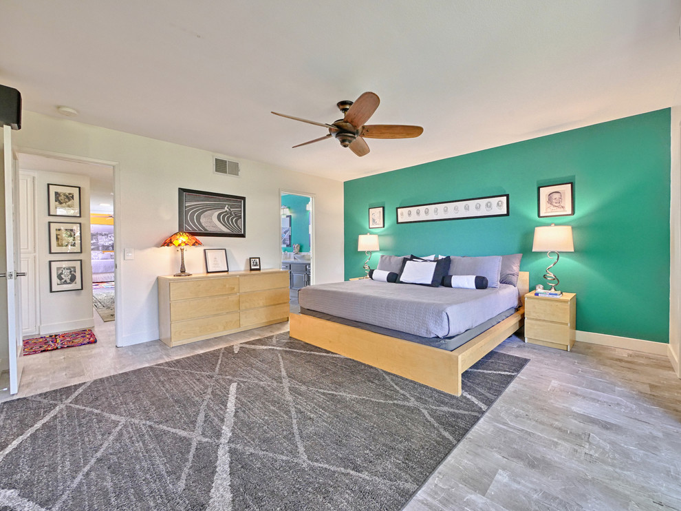 Ispirazione per una camera degli ospiti design di medie dimensioni con pareti verdi, pavimento in laminato e pavimento grigio