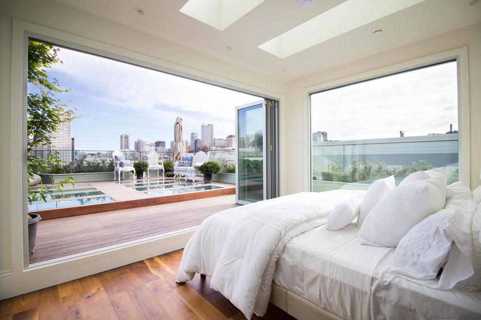 Inspiration for a contemporary bedroom in San Francisco with white walls and medium hardwood flooring.