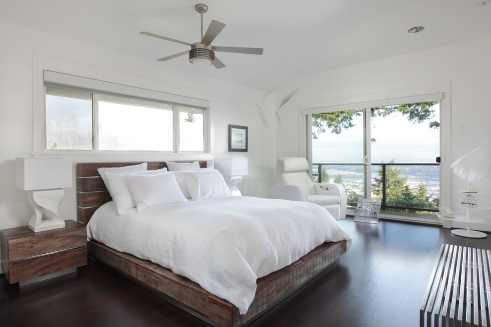 Example of a trendy dark wood floor bedroom design in Portland with white walls