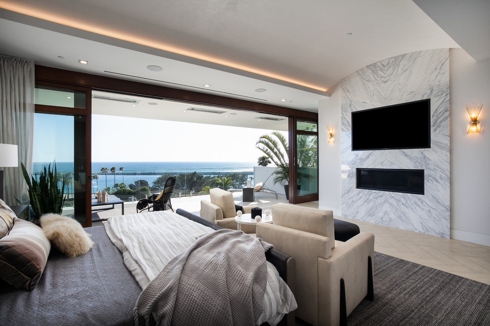 Стильный дизайн: большая хозяйская спальня в современном стиле с серыми стенами, светлым паркетным полом, горизонтальным камином, фасадом камина из камня и бежевым полом - последний тренд