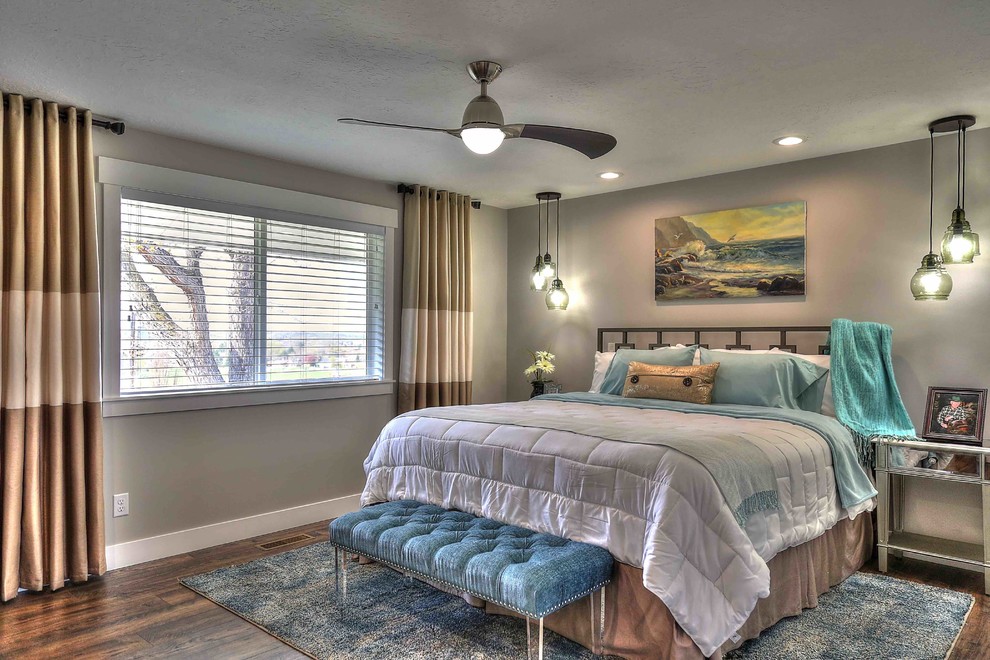 Medium sized contemporary master bedroom in Salt Lake City with grey walls, laminate floors, no fireplace and brown floors.