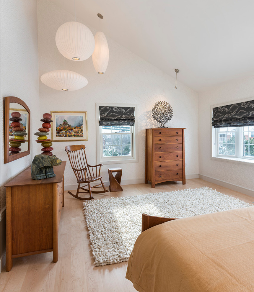 Modelo de dormitorio abovedado clásico renovado con paredes blancas, suelo de madera en tonos medios y suelo marrón