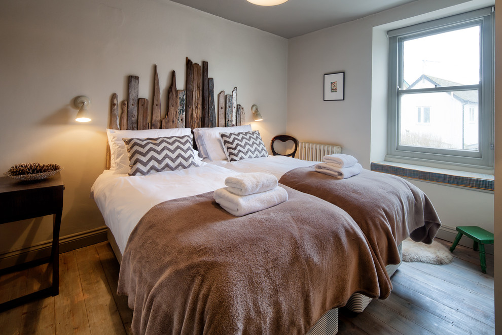 Bedroom - contemporary medium tone wood floor bedroom idea in Devon with blue walls