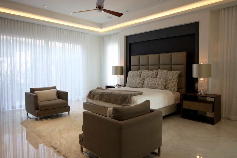 This is an example of a contemporary master bedroom in Miami with porcelain flooring.