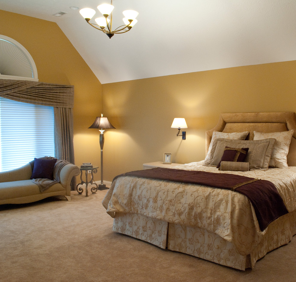 Inspiration for a large traditional master bedroom in Grand Rapids with yellow walls and carpet.
