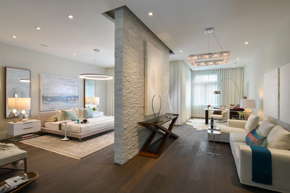 Photo of an expansive contemporary master and grey and brown bedroom in Miami with grey walls, dark hardwood flooring, brown floors, no fireplace and feature lighting.