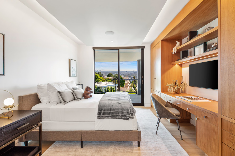 Bedroom - contemporary medium tone wood floor and brown floor bedroom idea in Los Angeles with white walls