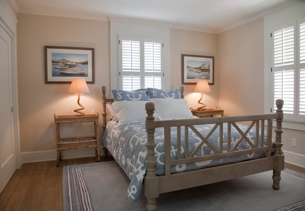 Mid-sized beach style guest medium tone wood floor bedroom photo in San Diego with beige walls