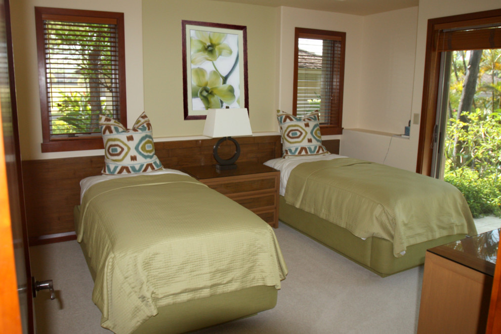Example of a small island style guest carpeted bedroom design in Hawaii with multicolored walls