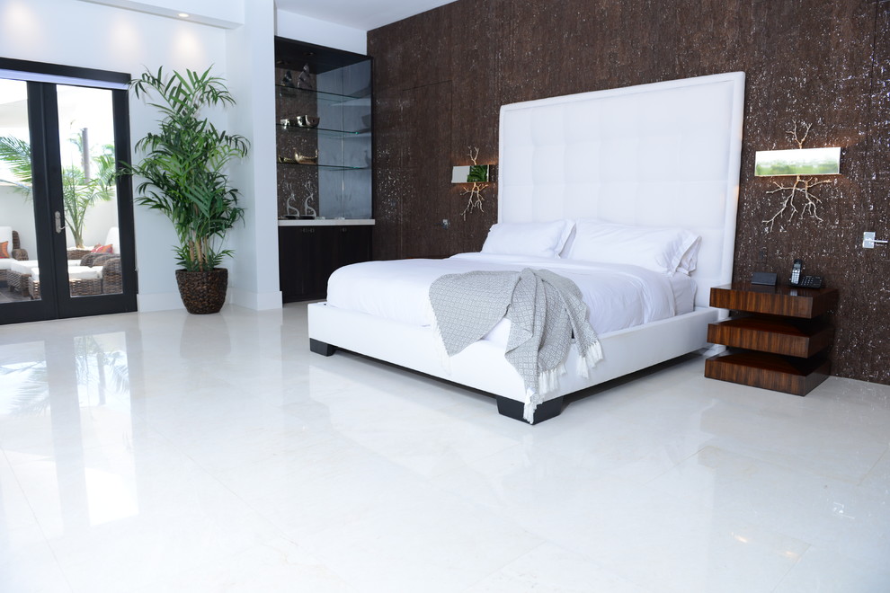 Large contemporary master bedroom in Miami with white walls, marble flooring and white floors.