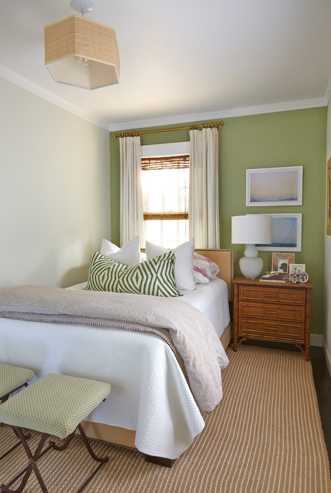 Small world-inspired guest bedroom in San Francisco with green walls and dark hardwood flooring.