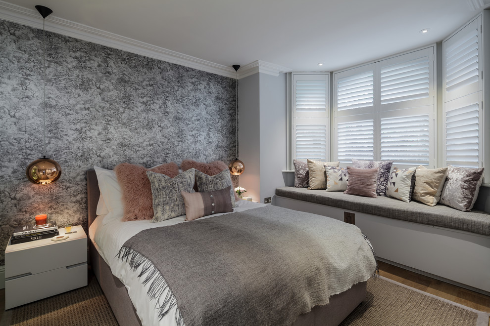 Medium sized eclectic master, grey and brown and grey and silver bedroom in London with grey walls, medium hardwood flooring and brown floors.