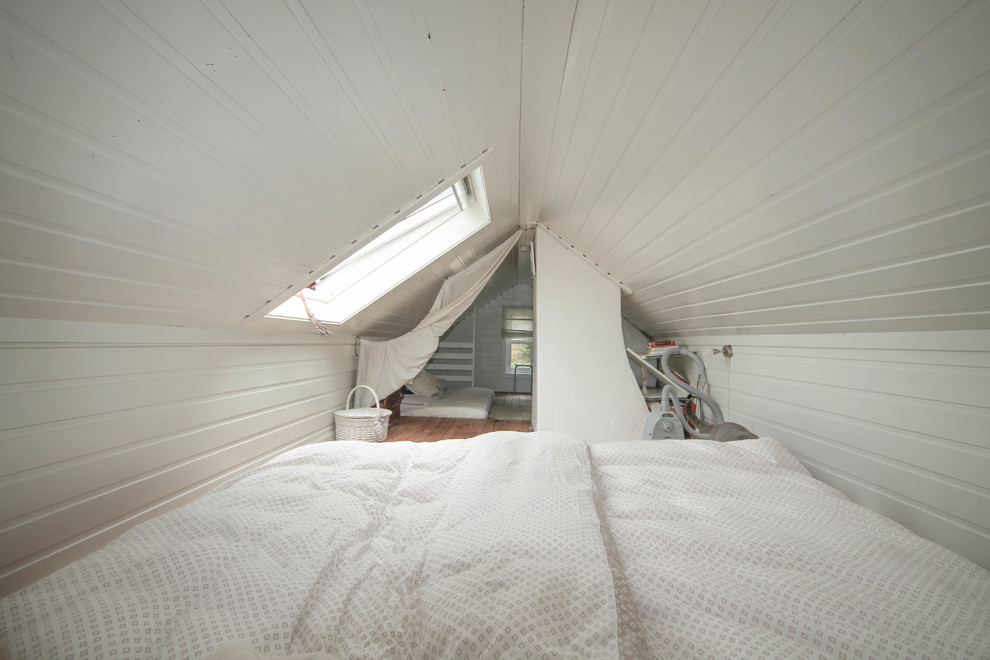 Inspiration för små nordiska sovloft, med vita väggar och mellanmörkt trägolv