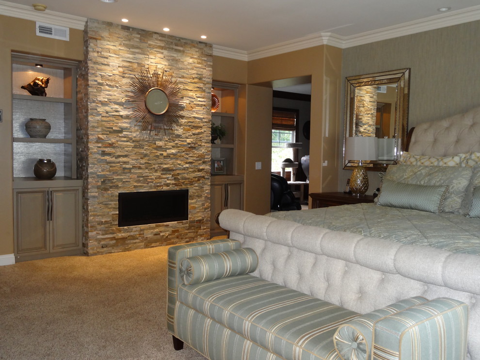 Imagen de dormitorio principal clásico renovado de tamaño medio con paredes beige, moqueta, chimenea lineal y marco de chimenea de piedra