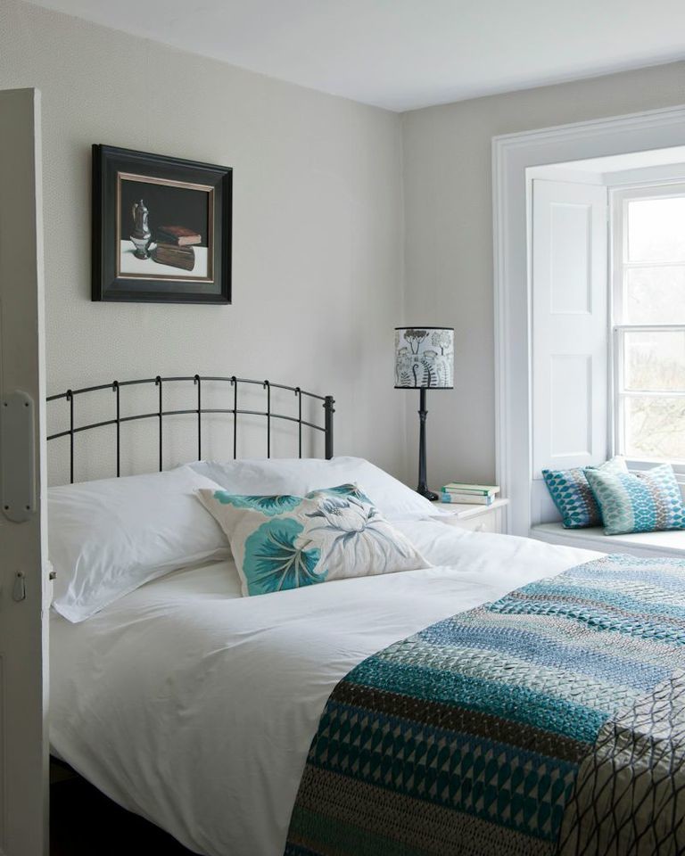 Bedroom - mid-sized country carpeted bedroom idea in London with beige walls and no fireplace