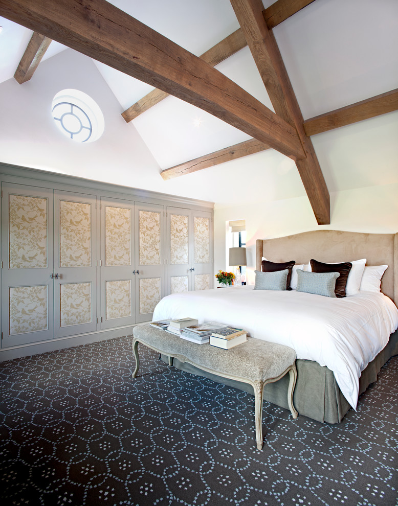 This is an example of a traditional bedroom in London with white walls and carpet.