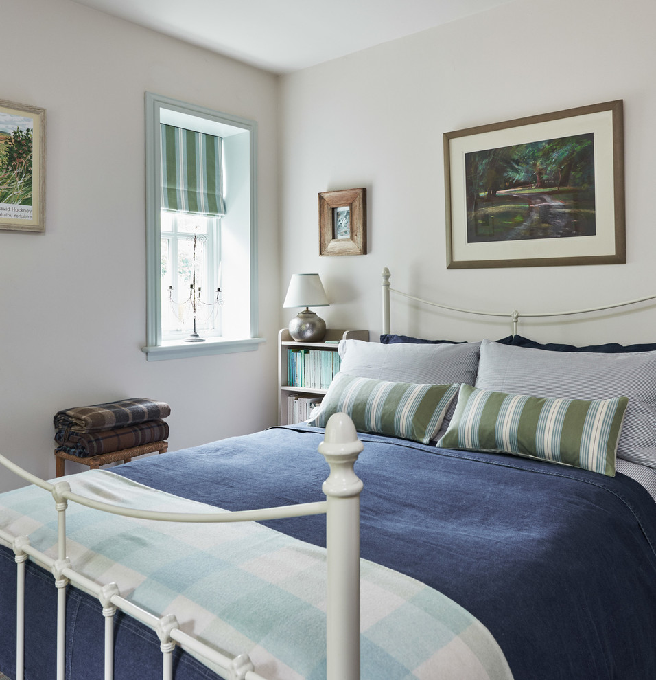 This is an example of a medium sized coastal guest bedroom in Other with white walls.