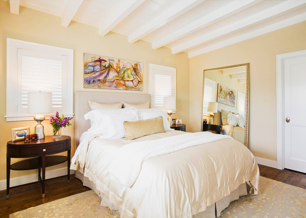 Elegant dark wood floor and brown floor bedroom photo in Los Angeles with beige walls and no fireplace