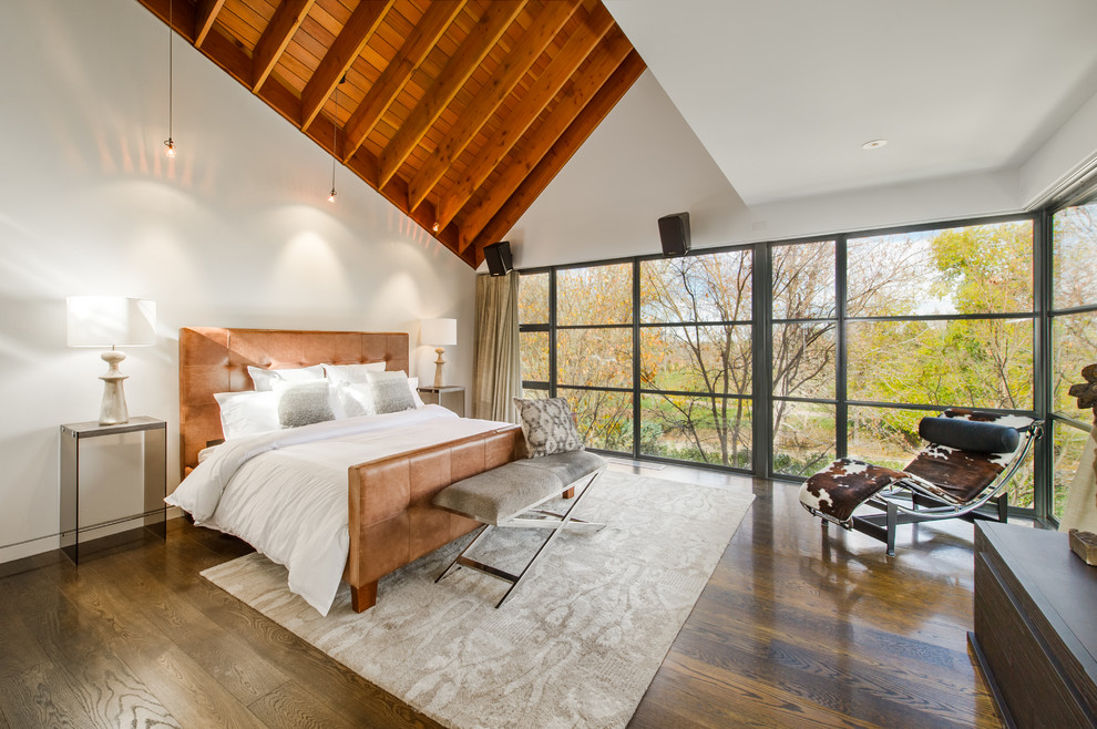 Photo of a contemporary bedroom in Denver with white walls and dark hardwood flooring.