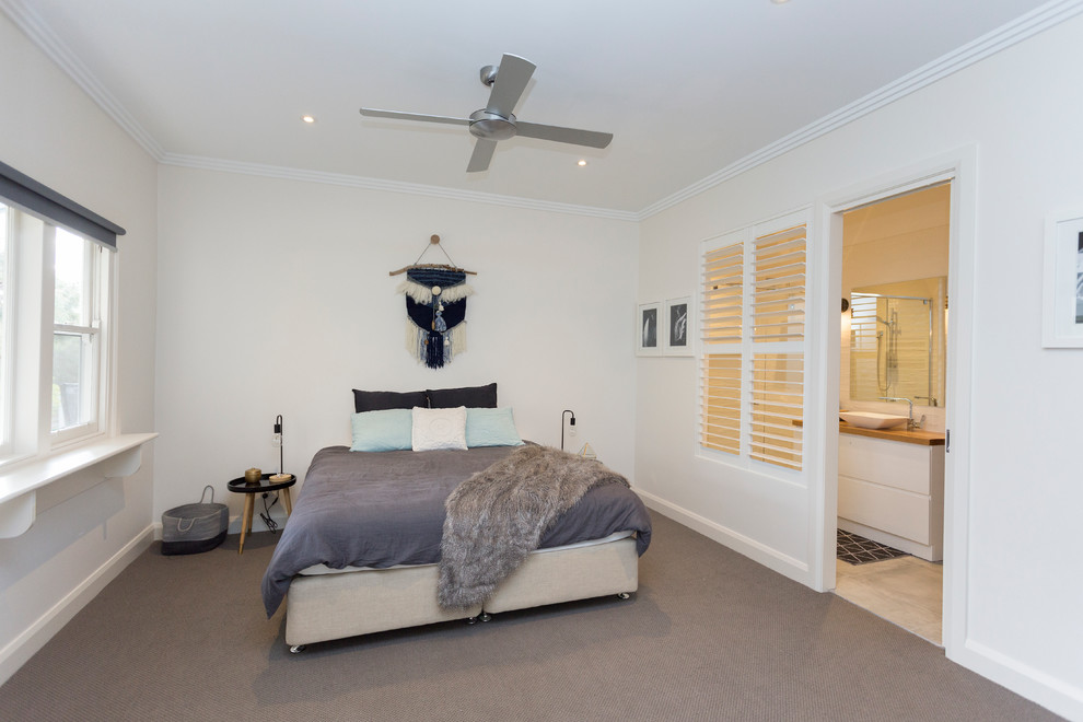 Example of a large trendy master carpeted and gray floor bedroom design in Melbourne with white walls and no fireplace