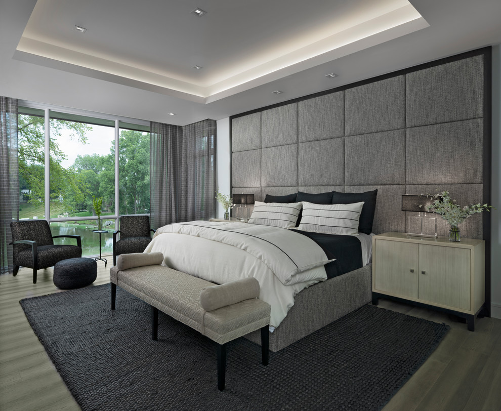 Photo of a contemporary master and grey and black bedroom in Detroit with no fireplace and brown floors.