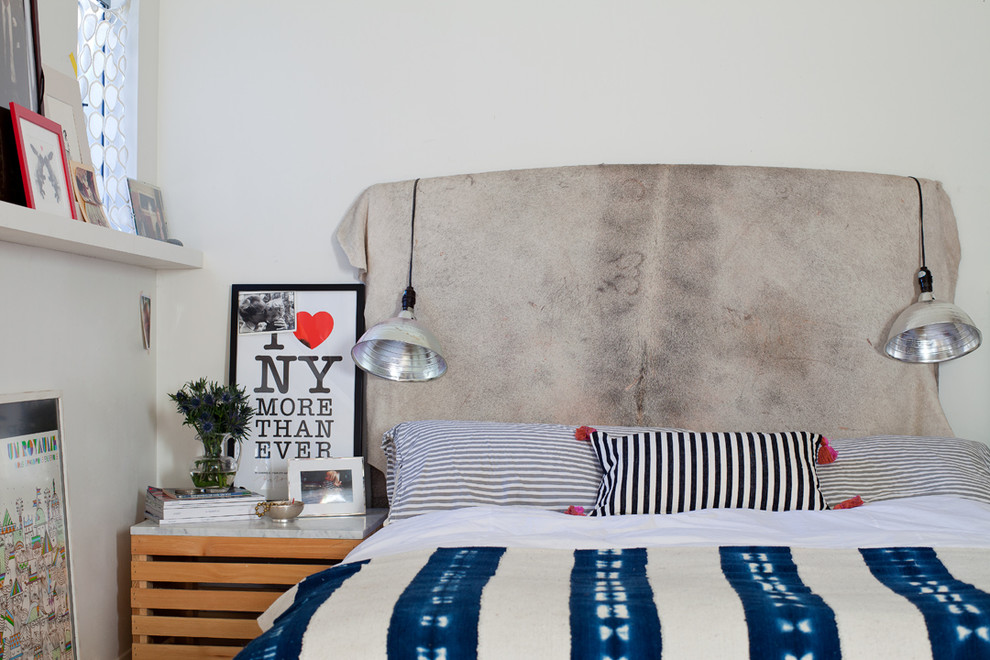 Example of an eclectic bedroom design with white walls