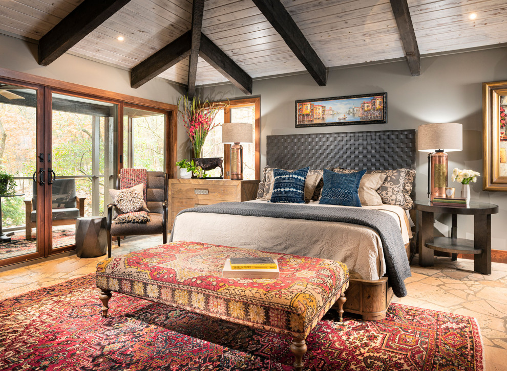 Photo of a large rustic master bedroom in Other with grey walls.