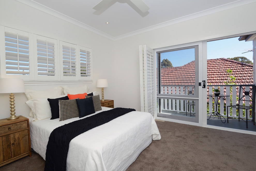 Medium sized contemporary guest bedroom in Sydney with white walls and carpet.
