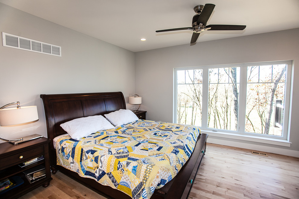 Bedroom - large craftsman master light wood floor bedroom idea in St Louis with gray walls