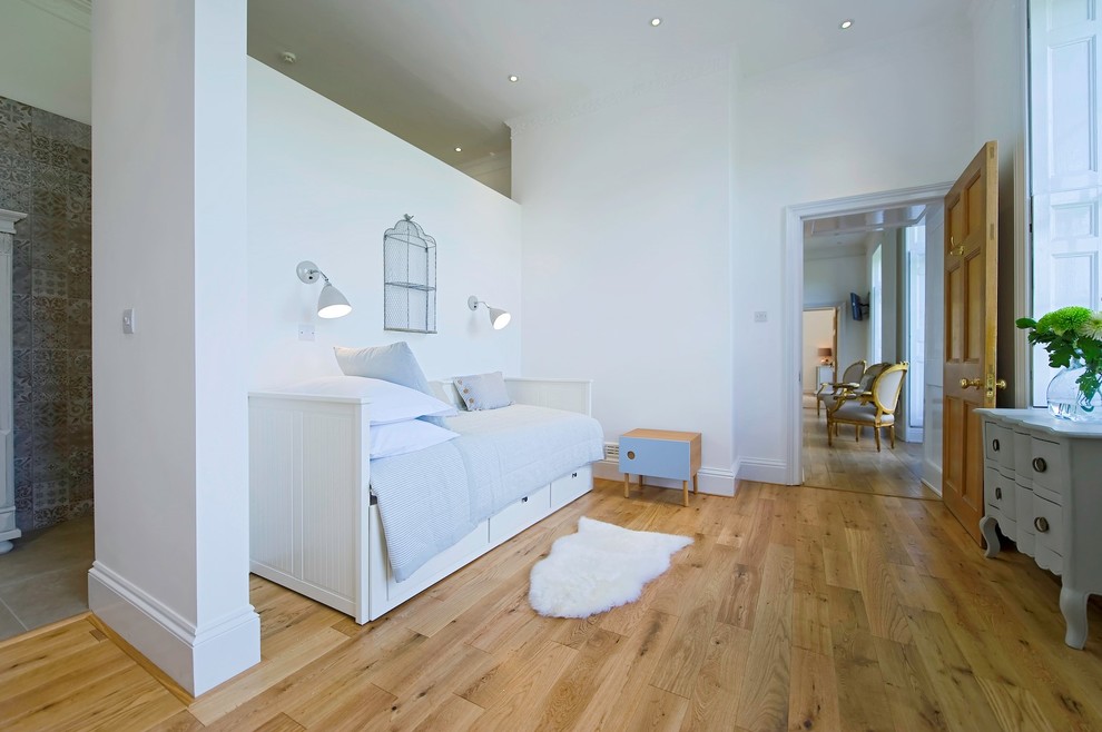 Design ideas for a contemporary bedroom in Surrey with medium hardwood flooring.