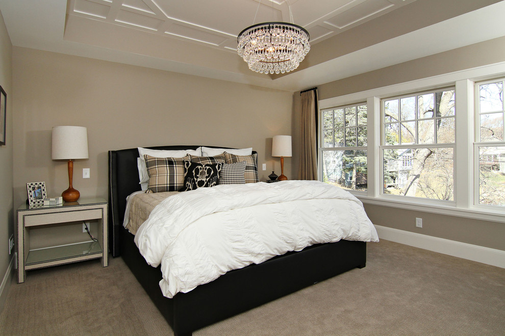 This is an example of a large traditional master bedroom in Minneapolis with beige walls, carpet and no fireplace.