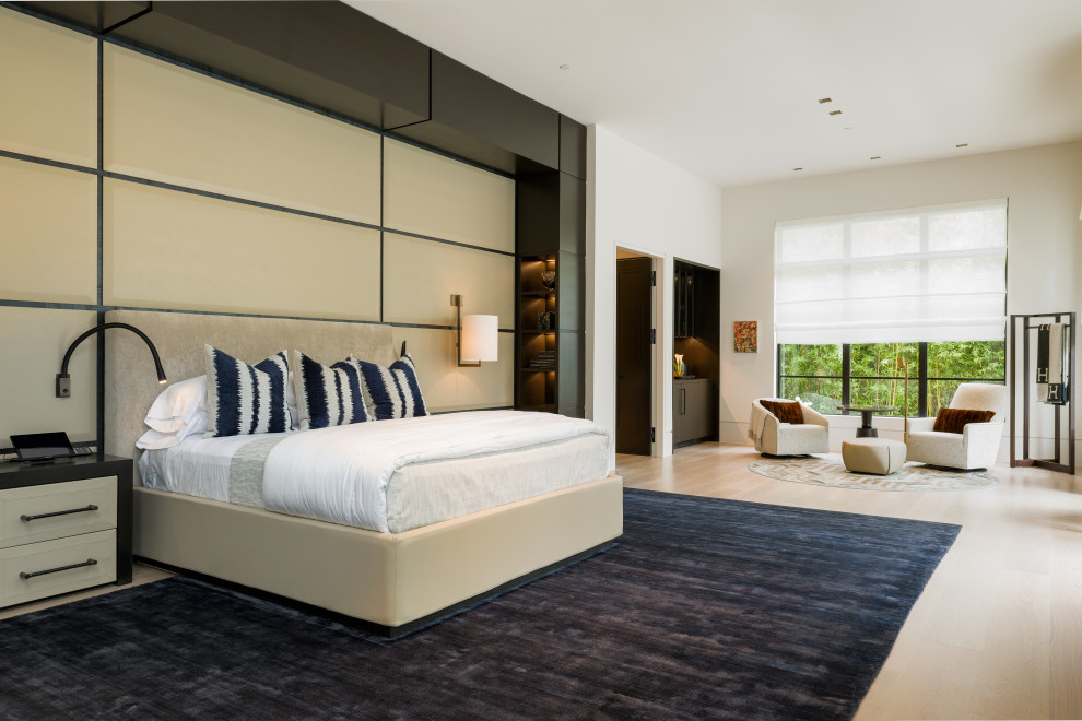 Large midcentury master bedroom in Dallas with beige walls, light hardwood flooring, a ribbon fireplace, a stone fireplace surround and beige floors.